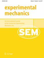 The cover of the Experimental Mechanics Journal on a bright mustard yellow background with title on top left portion in yellow letters 